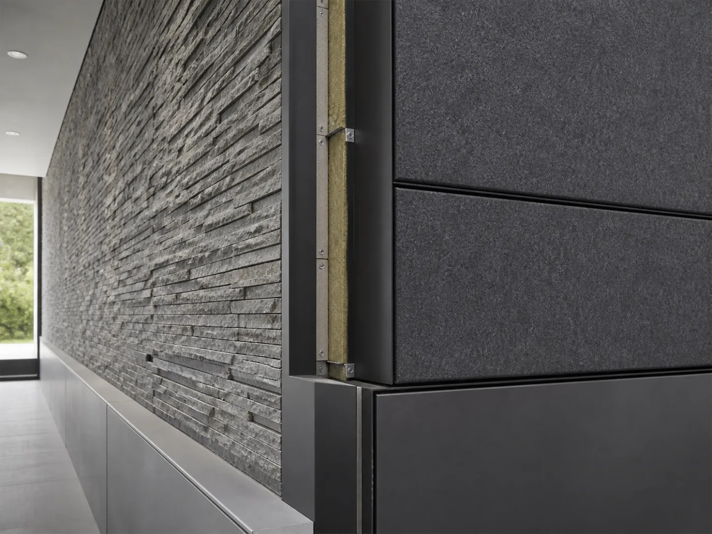 A detailed wall junction showing stone veneer, metal trim, insulation, and acoustic panels